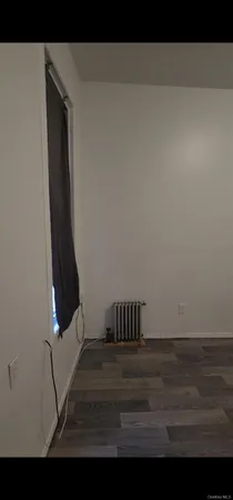 a view of a livingroom with an empty space and a car parked on the wall