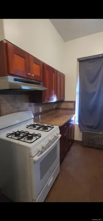 a stove top oven sitting inside of a kitchen