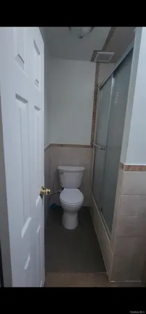 a bathroom with a toilet and a shower