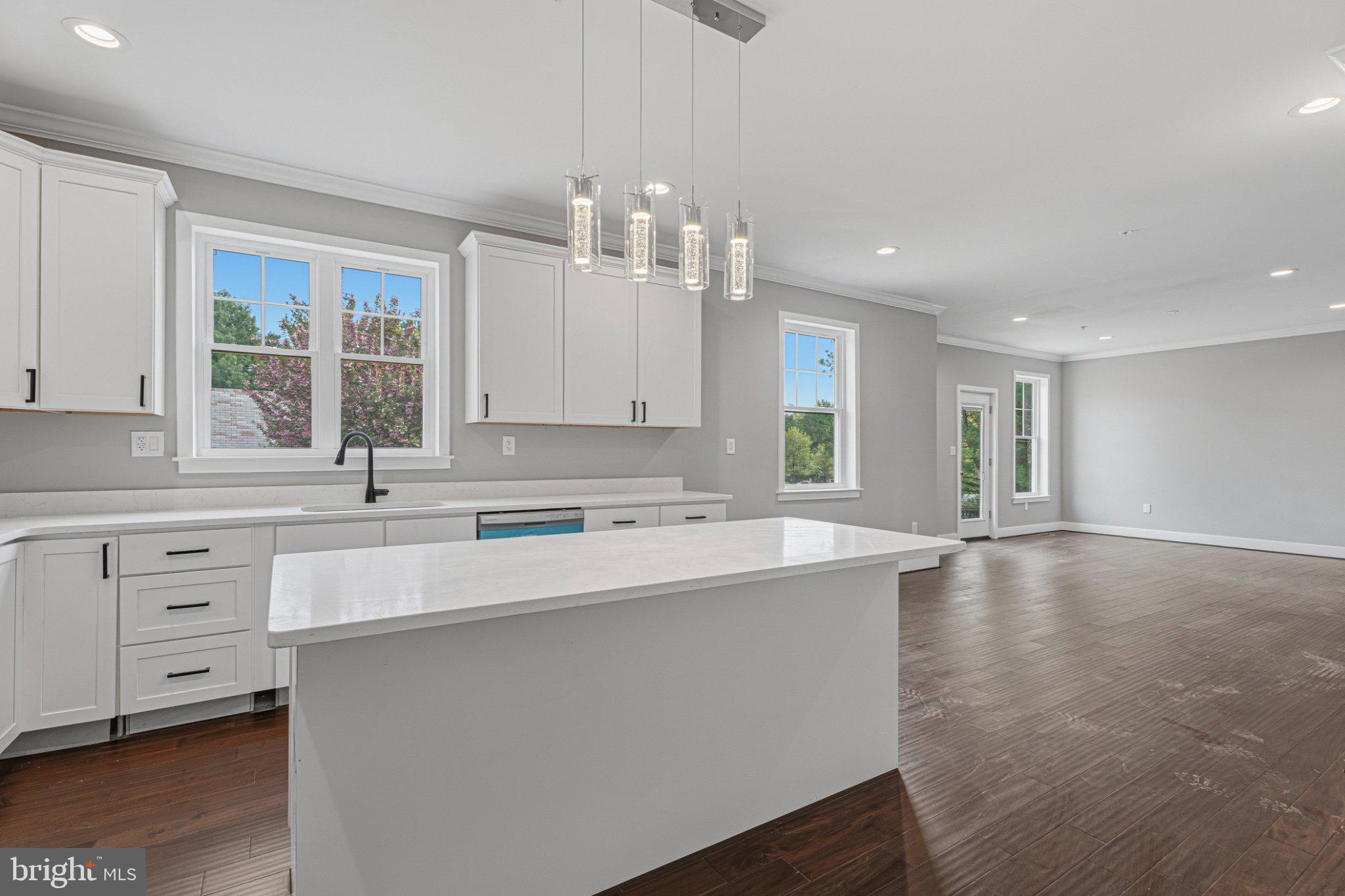 4100 Taylor Avenue Baltimore, MD 21236 - Photo 15 of 57 a large kitchen with kitchen island white cabinets and stainless steel appliances