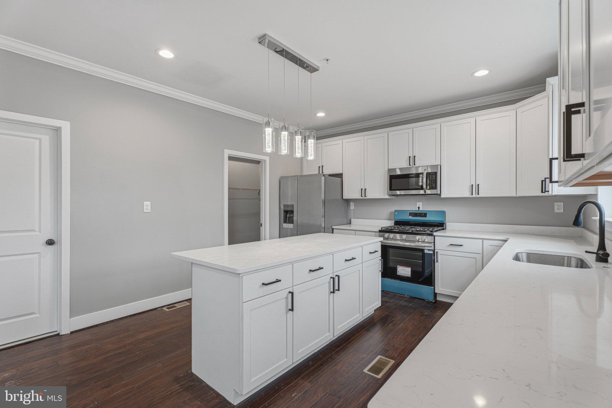 4100 Taylor Avenue Baltimore, MD 21236 - Photo 17 of 57 a kitchen with kitchen island granite countertop a sink stainless steel appliances and cabinets