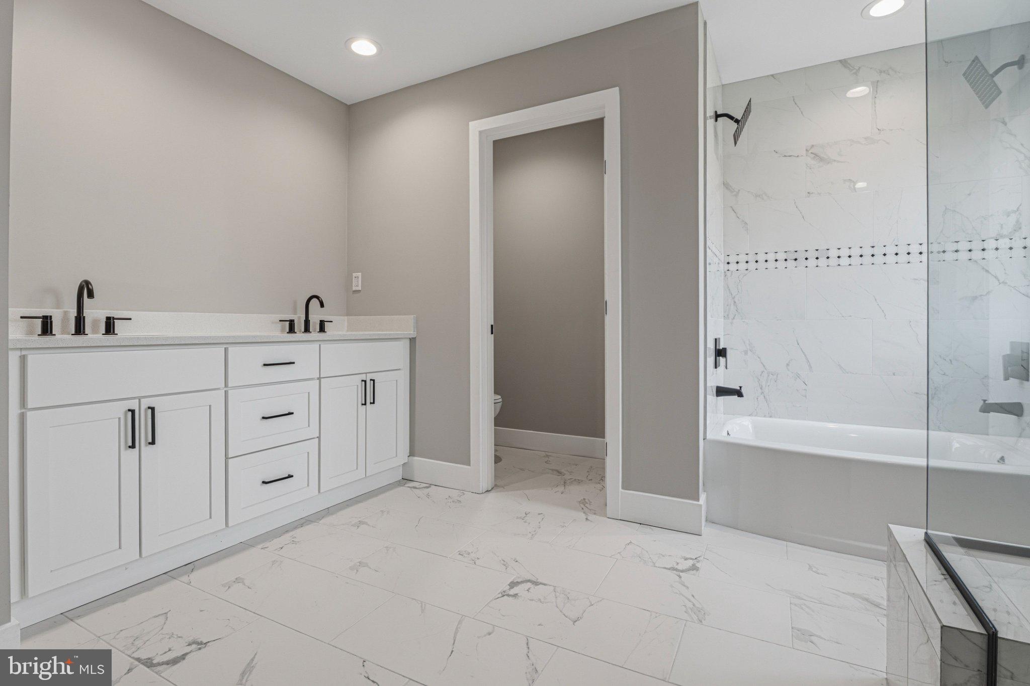 4100 Taylor Avenue Baltimore, MD 21236 - Photo 28 of 57 a spacious bathroom with a shower a sink and a bathtub
