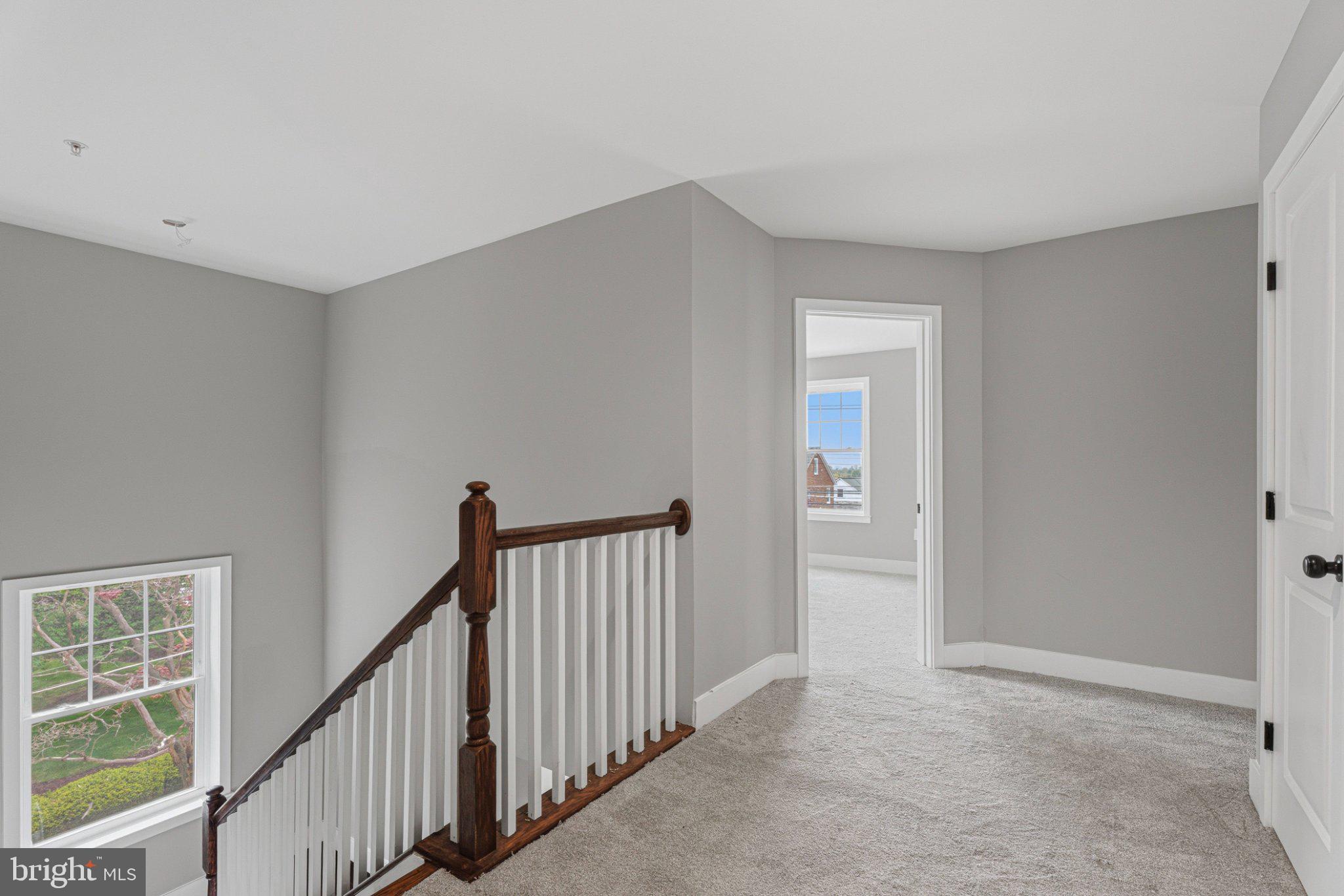 4100 Taylor Avenue Baltimore, MD 21236 - Photo 31 of 57 a view of a hallway with wooden floor and stairs