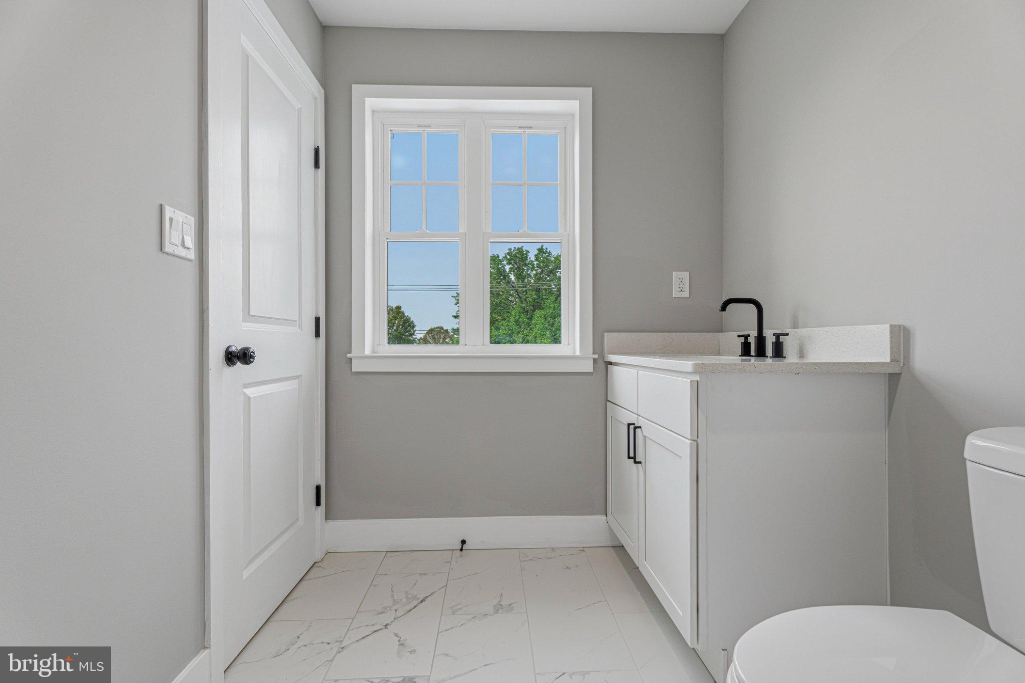 4100 Taylor Avenue Baltimore, MD 21236 - Photo 36 of 57 a bathroom with a toilet sink and mirror