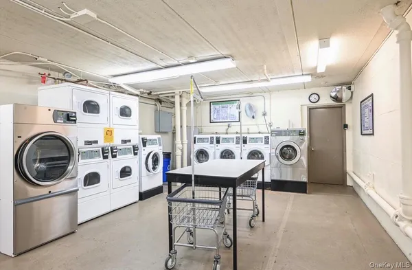 a utility room with multiple dryer and washer