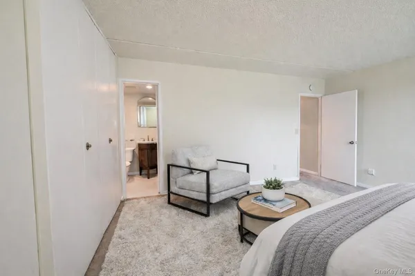 a bedroom with two beds and white walls