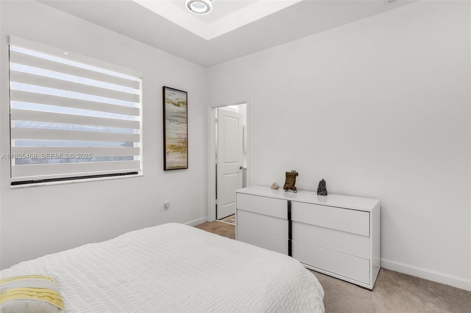 13315 Southwest 285th Street Homestead, FL 33033 - Photo 11 of 31 a bedroom with a bed and a window