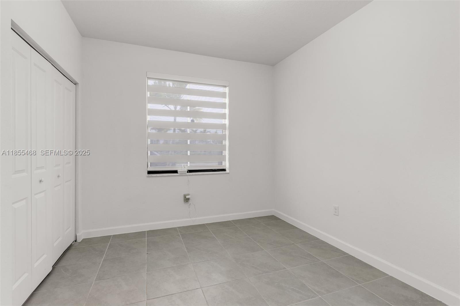 13315 Southwest 285th Street Homestead, FL 33033 - Photo 14 of 31 a view of an empty room with a window