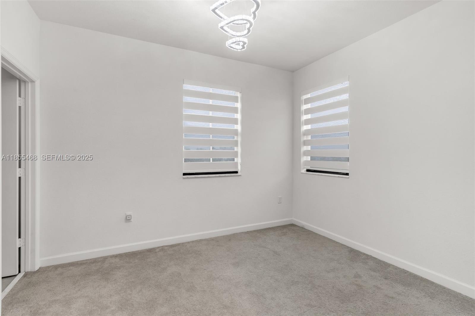 13315 Southwest 285th Street Homestead, FL 33033 - Photo 16 of 31 an empty room with windows and cabinet