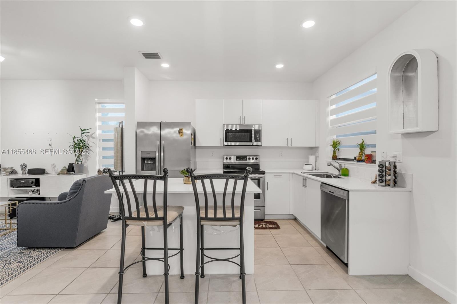 13315 Southwest 285th Street Homestead, FL 33033 - Photo 3 of 31 a kitchen with cabinets and chairs