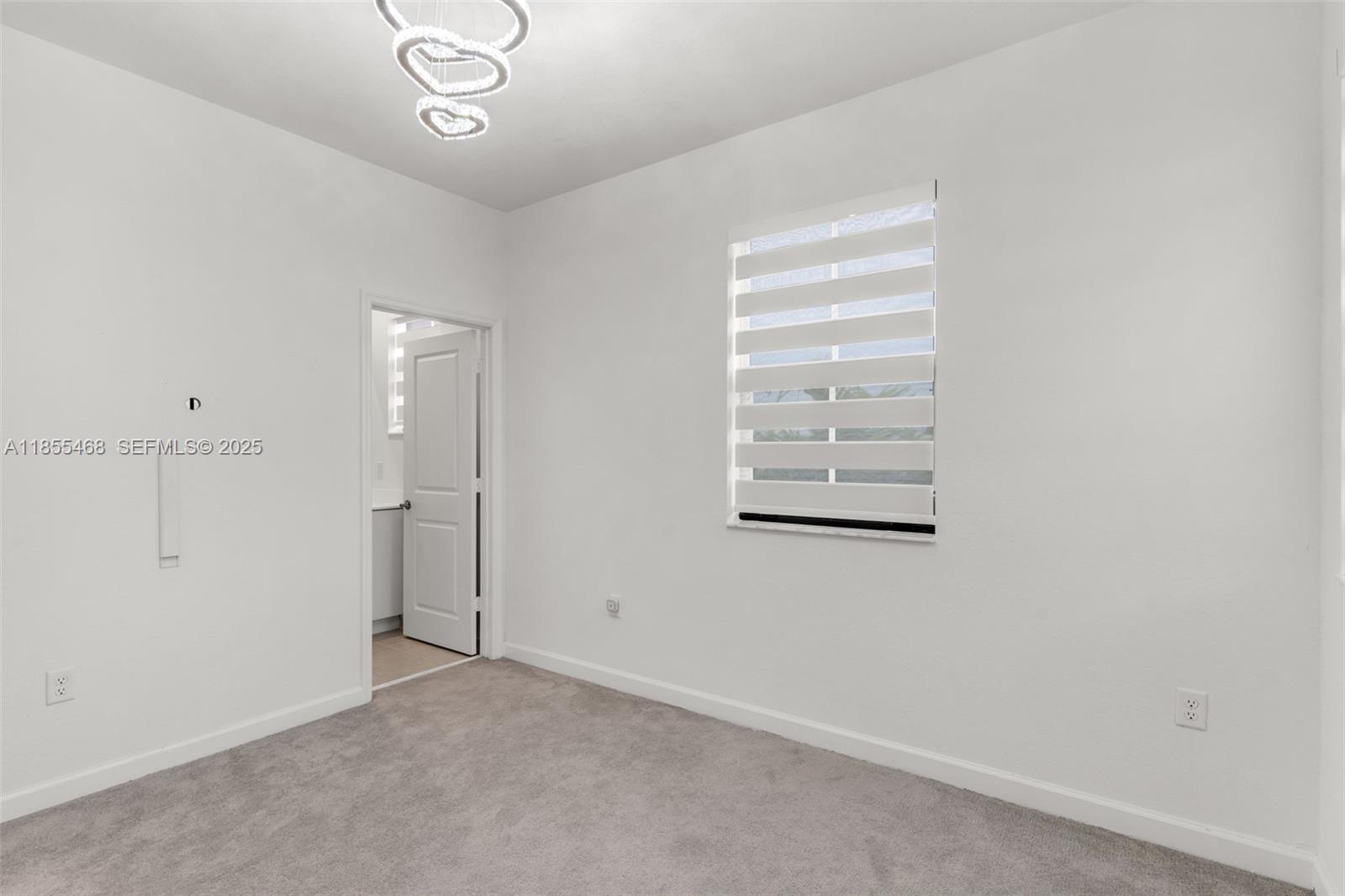 13315 Southwest 285th Street Homestead, FL 33033 - Photo 9 of 31 an empty room with windows and closet