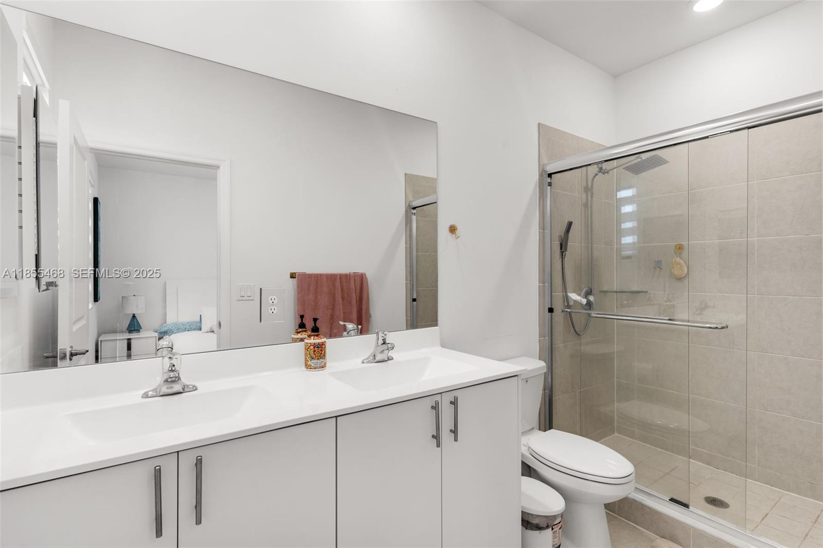 13315 Southwest 285th Street Homestead, FL 33033 - Photo 10 of 31 a bathroom with a sink toilet double vanity and shower