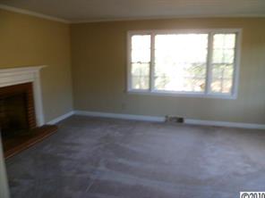 13936 Shopton Road West Charlotte, NC 28278 - Photo 3 of 16 an empty room with a fireplace