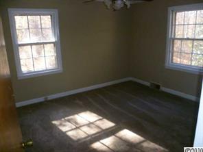 13936 Shopton Road West Charlotte, NC 28278 - Photo 4 of 16 an empty room with wooden floor and windows