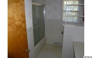 13936 Shopton Road West Charlotte, NC 28278 - Photo 10 of 16 a bathroom with a glass shower door