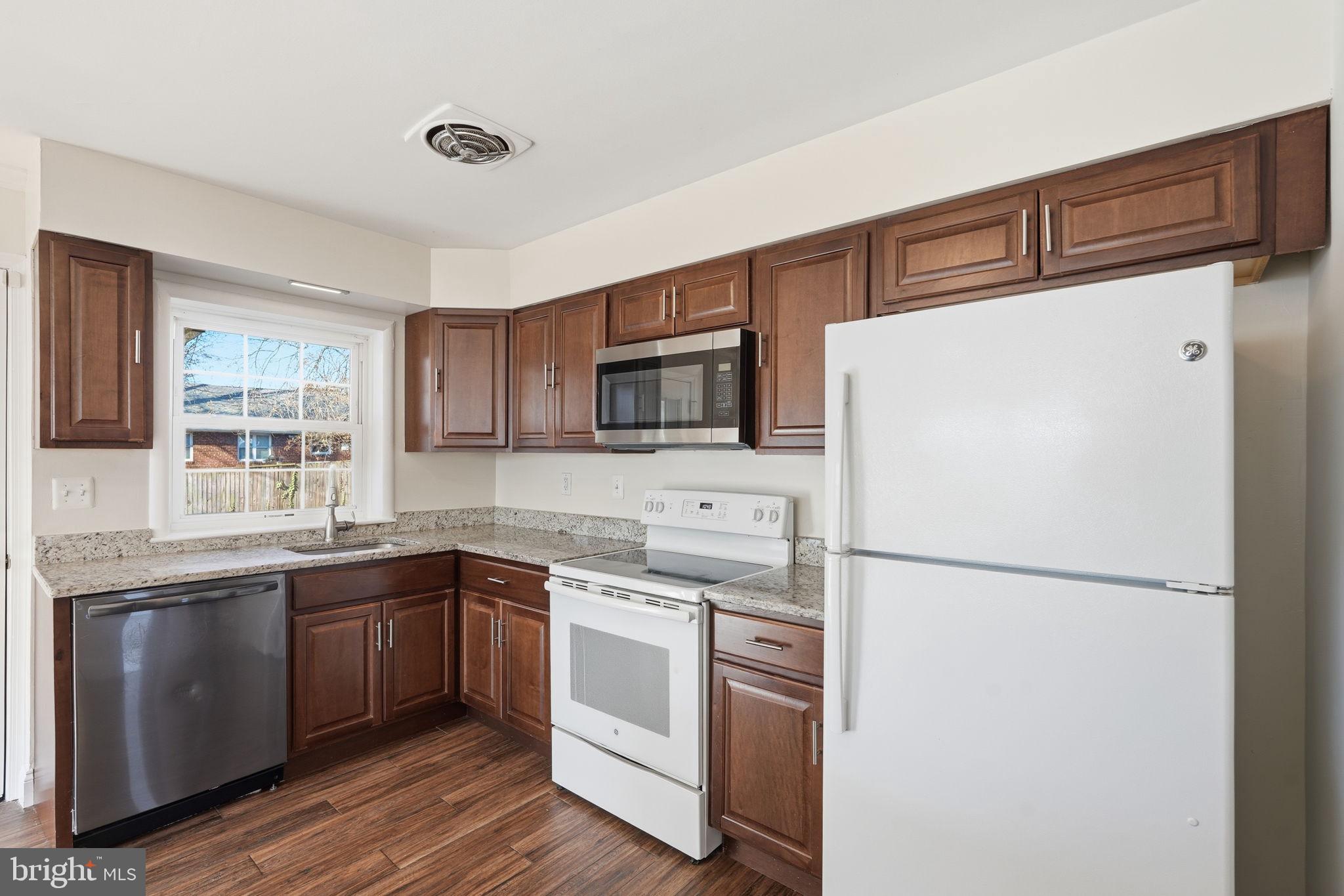 9708 Dameron Drive Silver Spring, MD 20910 - Photo 11 of 38 a kitchen with a sink a refrigerator and cabinets