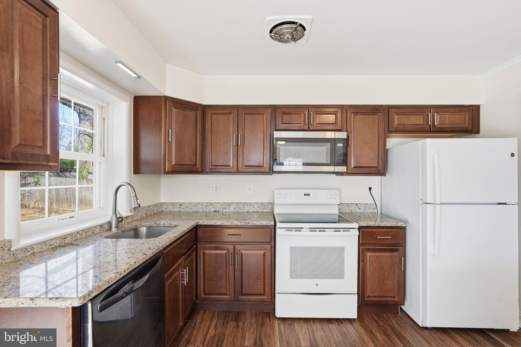 9708 Dameron Drive Silver Spring, MD 20910 - Photo 13 of 38 a kitchen with a sink a stove a refrigerator and cabinets
