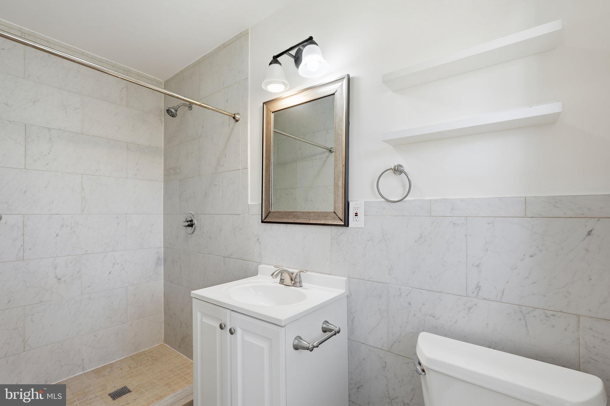9708 Dameron Drive Silver Spring, MD 20910 - Photo 18 of 38 a bathroom with a sink a toilet and shower