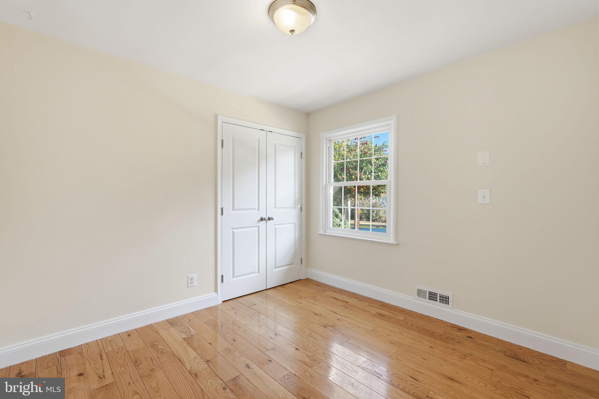 9708 Dameron Drive Silver Spring, MD 20910 - Photo 19 of 38 an empty room with wooden floor and windows