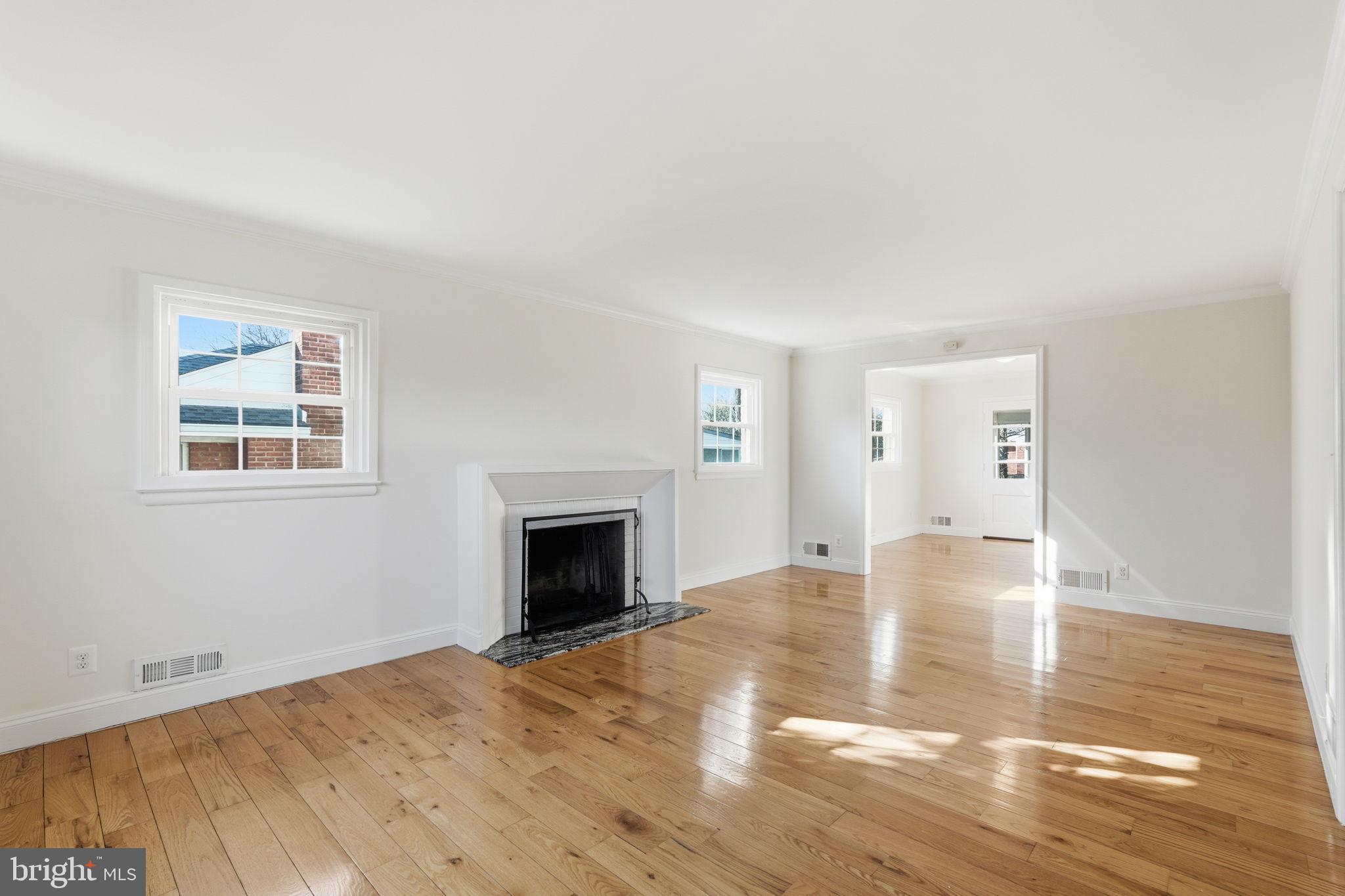 9708 Dameron Drive Silver Spring, MD 20910 - Photo 2 of 38 a view of empty room with wooden floor and fireplace