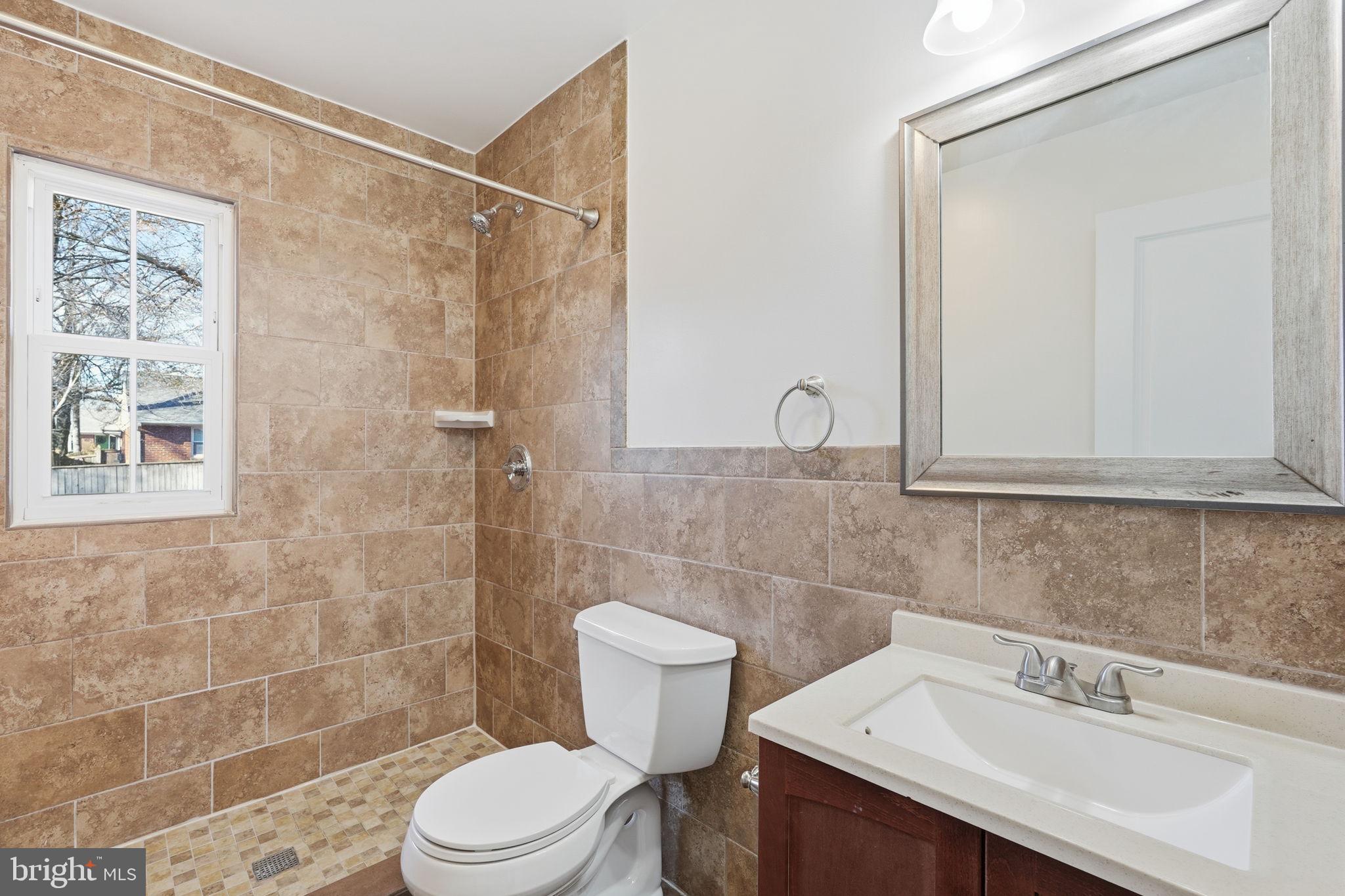 9708 Dameron Drive Silver Spring, MD 20910 - Photo 21 of 38 a bathroom with a sink a toilet and shower