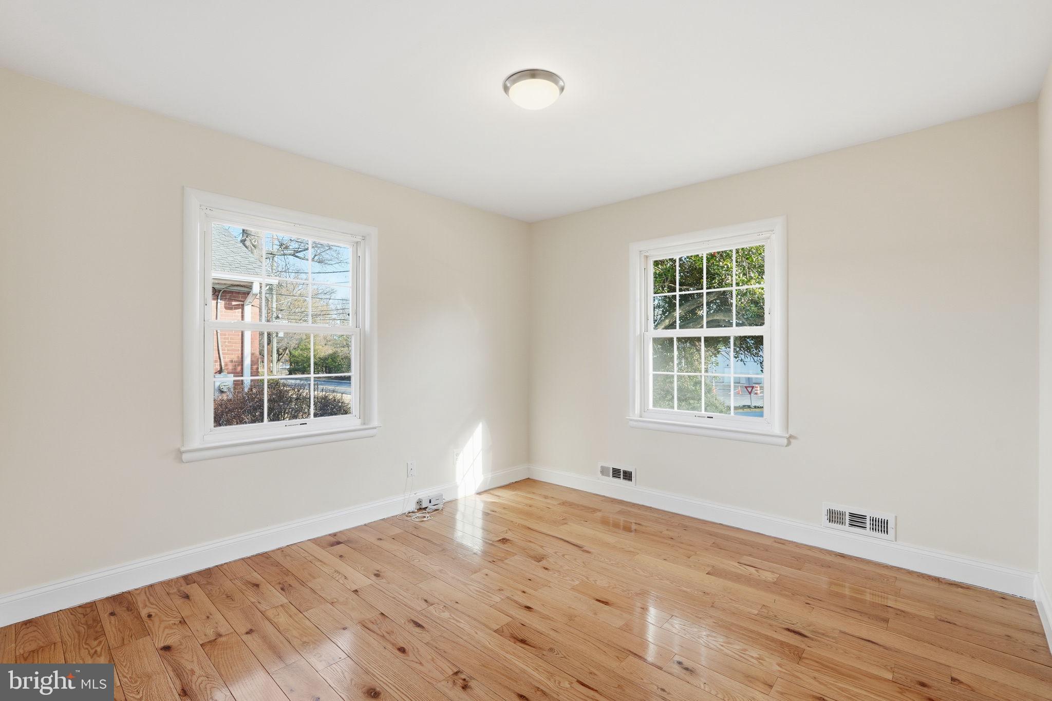 9708 Dameron Drive Silver Spring, MD 20910 - Photo 22 of 38 an empty room with wooden floor and windows