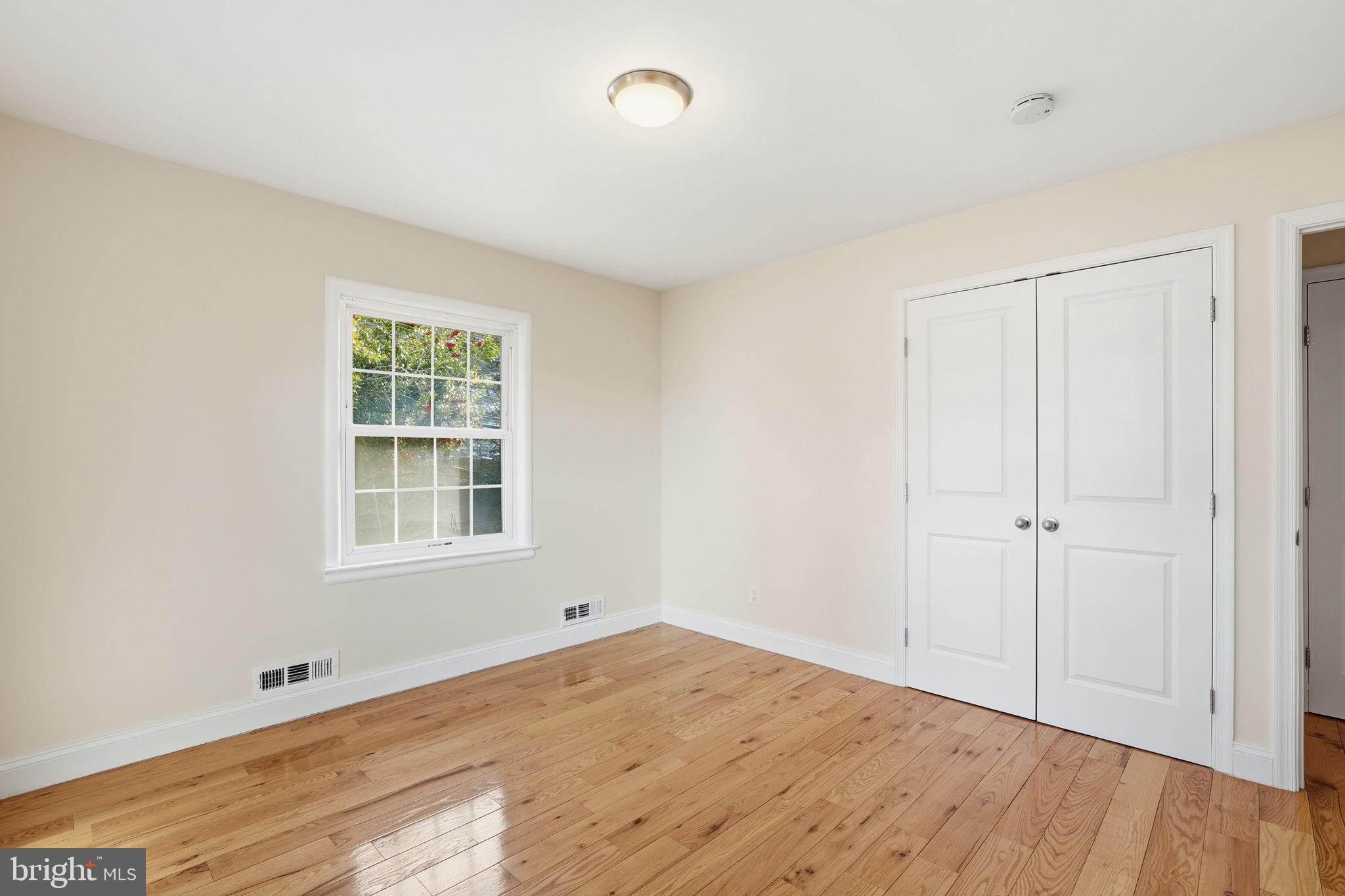 9708 Dameron Drive Silver Spring, MD 20910 - Photo 23 of 38 an empty room with wooden floor and windows