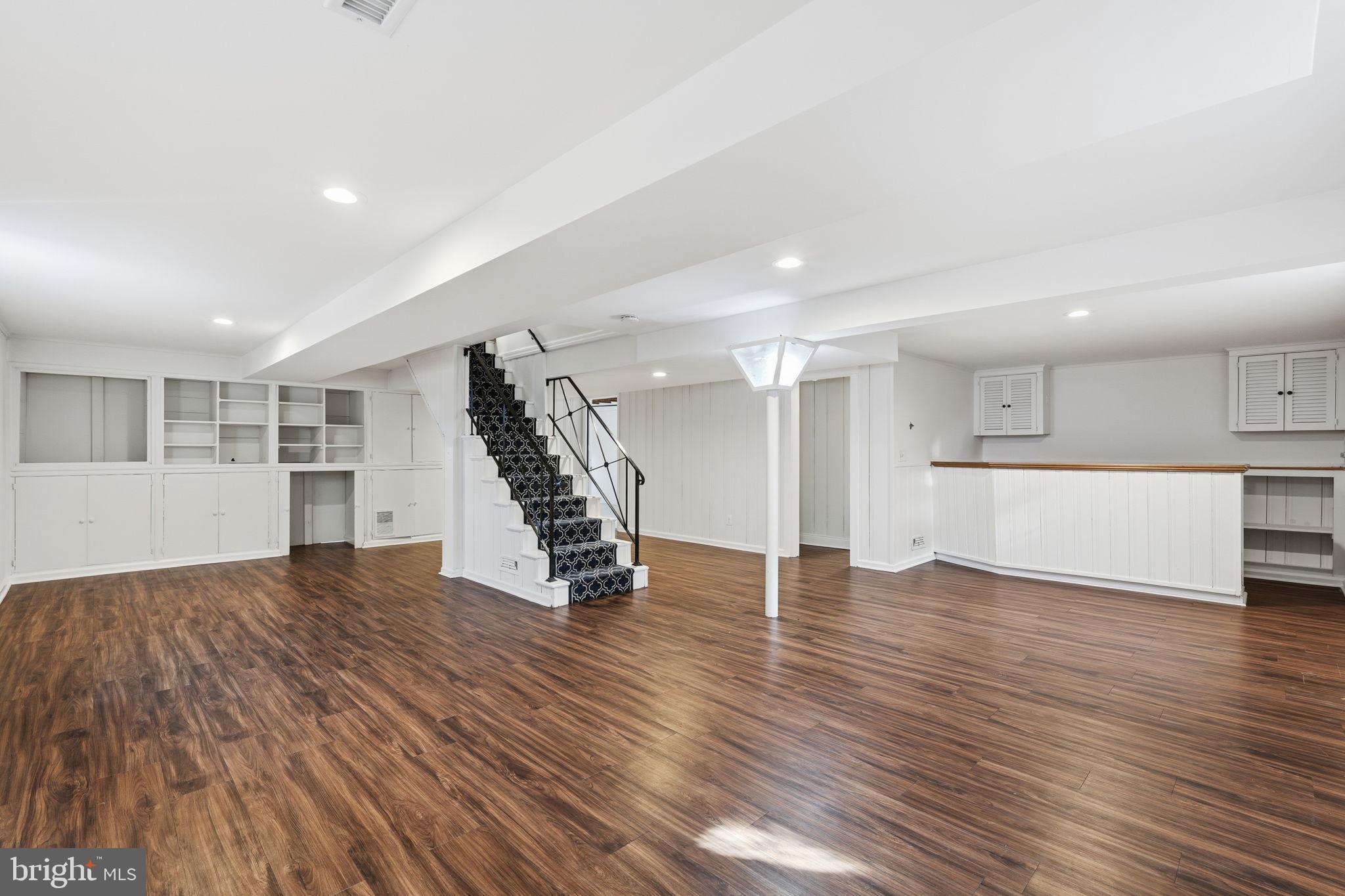 9708 Dameron Drive Silver Spring, MD 20910 - Photo 25 of 38 a view of an empty room with wooden floor and kitchen