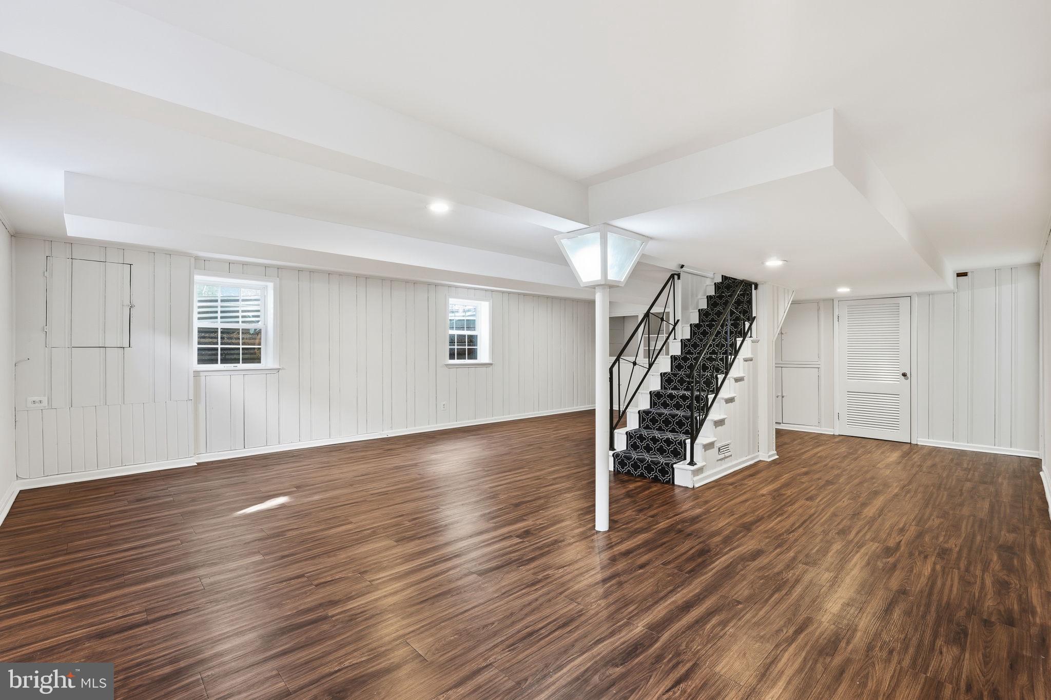9708 Dameron Drive Silver Spring, MD 20910 - Photo 26 of 38 a view of an empty room with wooden floor stairs and a window