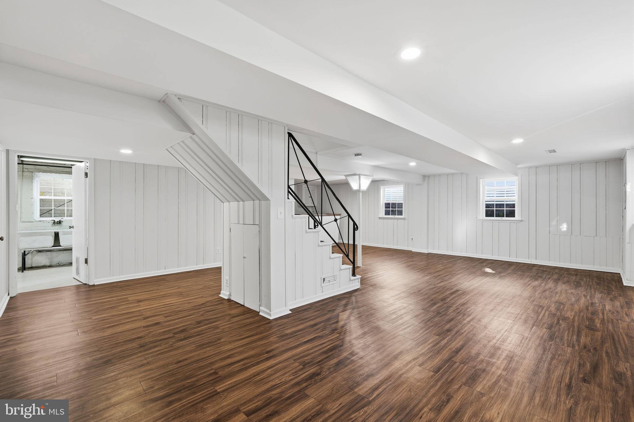 9708 Dameron Drive Silver Spring, MD 20910 - Photo 27 of 38 a view of a livingroom with wooden floor and stairs