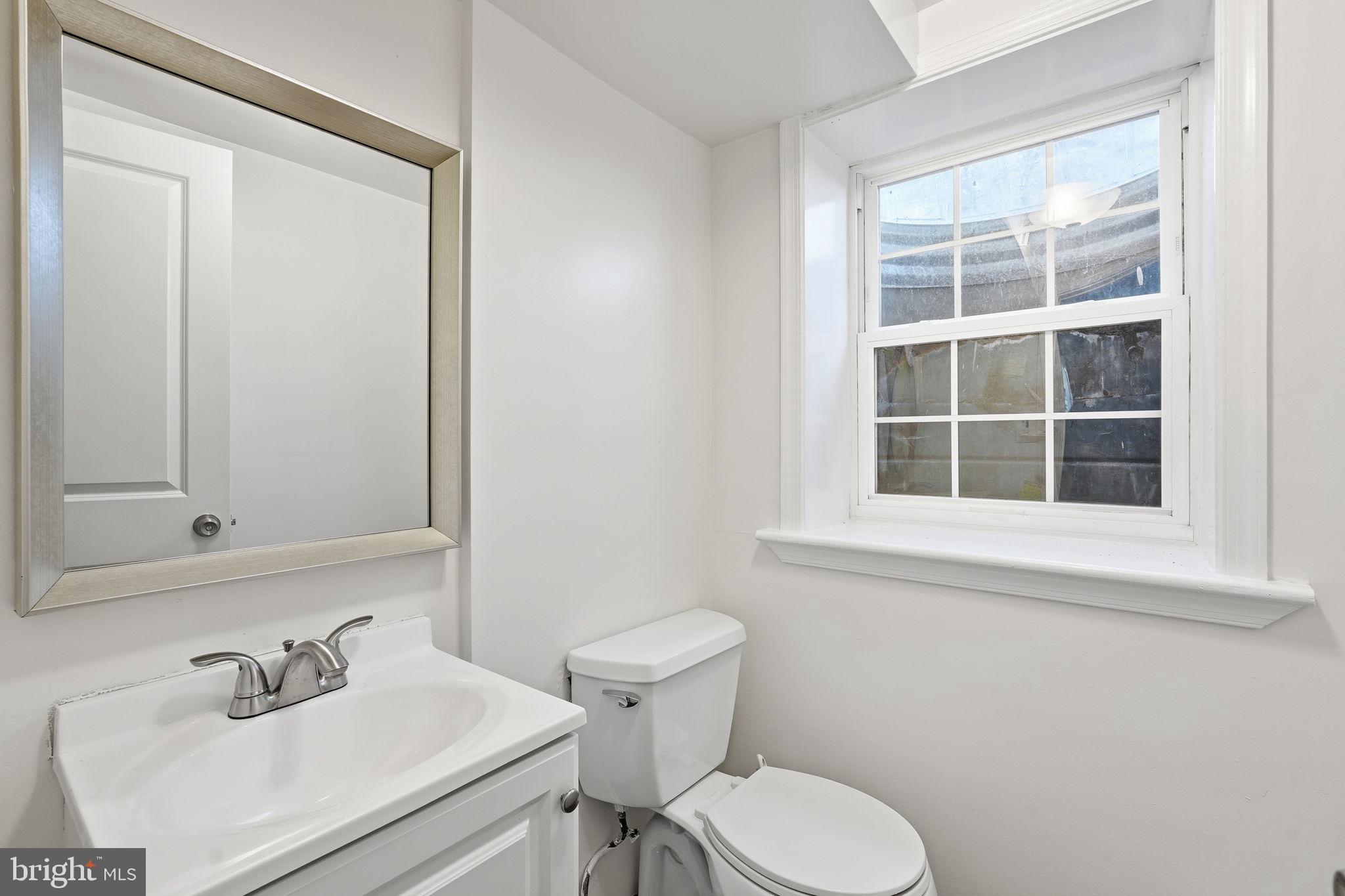 9708 Dameron Drive Silver Spring, MD 20910 - Photo 30 of 38 a bathroom with a sink mirror and toilet