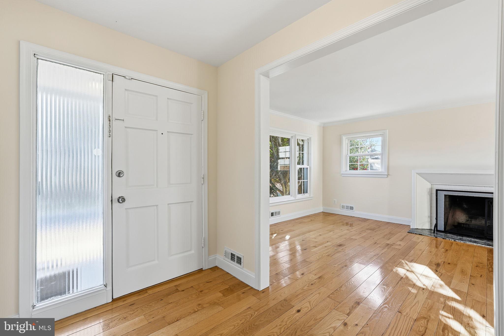 9708 Dameron Drive Silver Spring, MD 20910 - Photo 4 of 38 an empty room with windows and fireplace