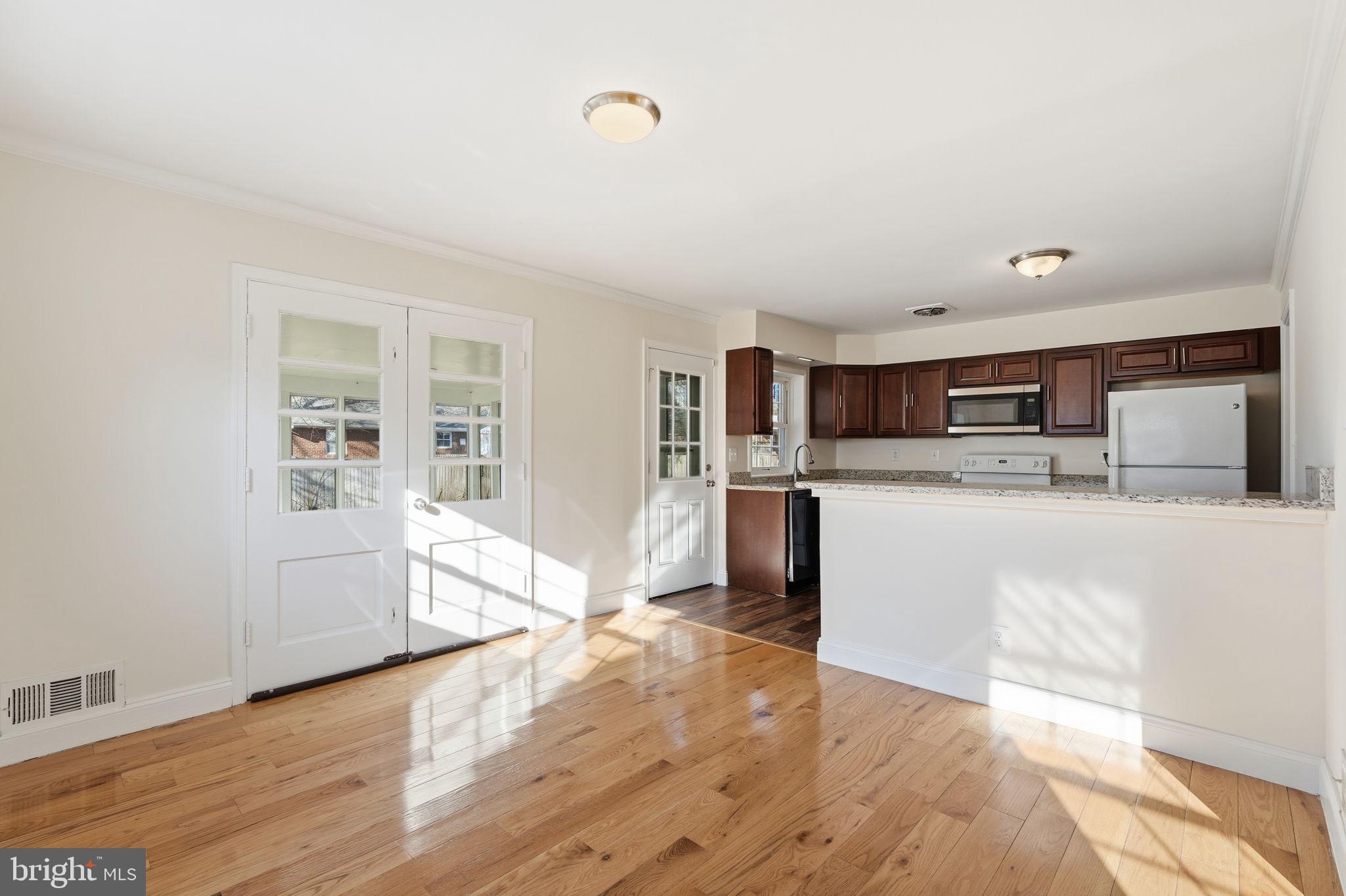 9708 Dameron Drive Silver Spring, MD 20910 - Photo 7 of 38 a kitchen with stainless steel appliances a refrigerator and a stove top oven