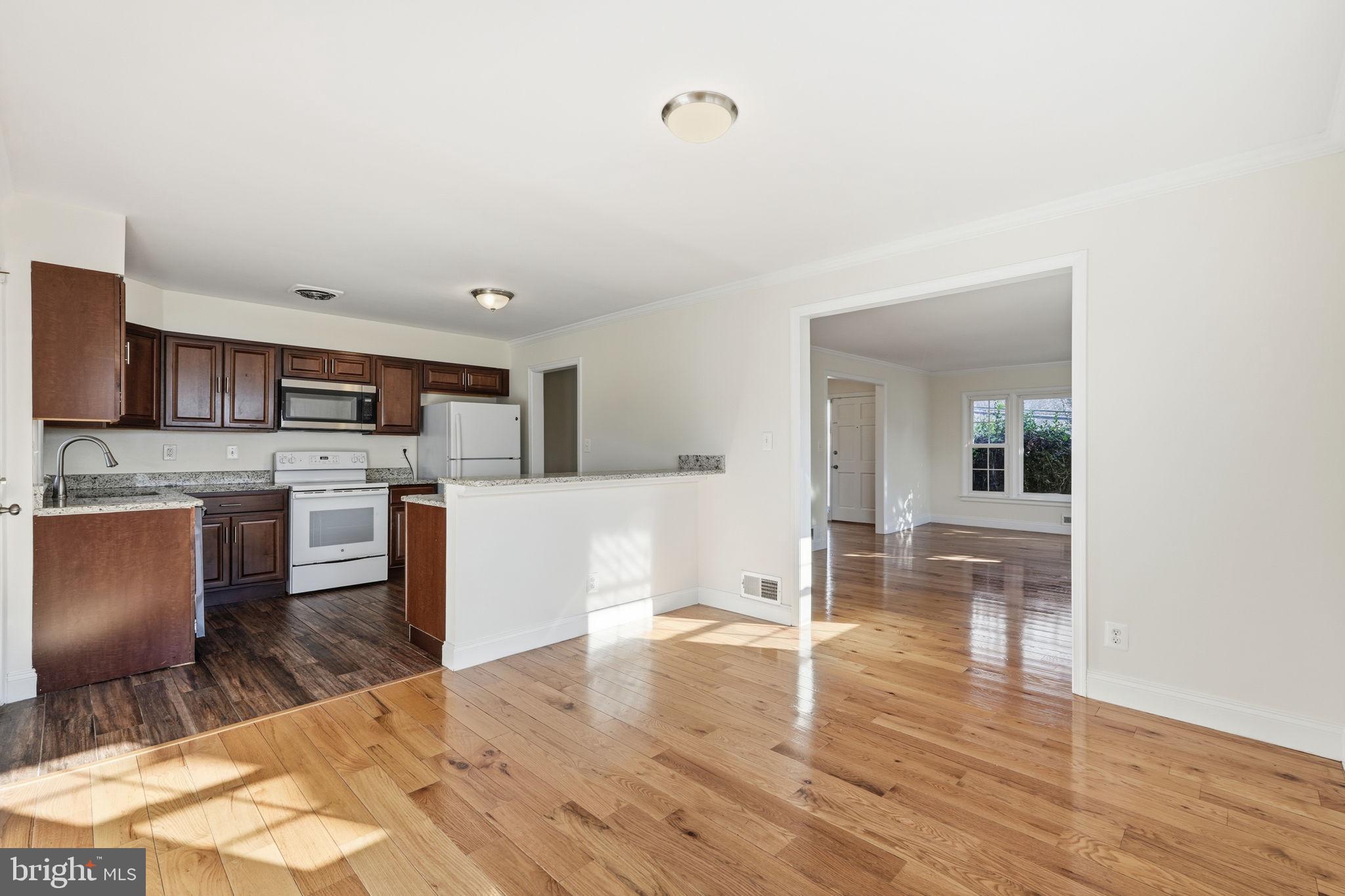 9708 Dameron Drive Silver Spring, MD 20910 - Photo 8 of 38 a kitchen with stainless steel appliances granite countertop a stove top oven a sink a counter space and cabinets
