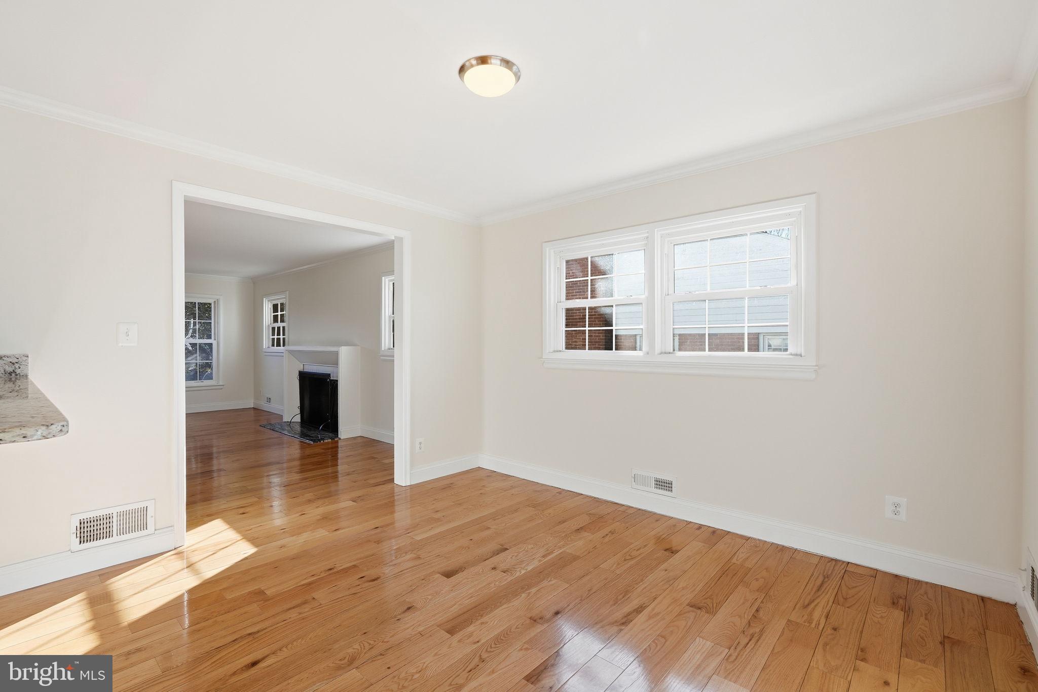 9708 Dameron Drive Silver Spring, MD 20910 - Photo 9 of 38 a view of empty room with wooden floor and windows
