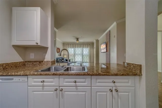 a kitchen with sink and cabinets