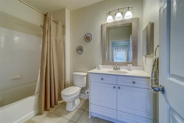 a bathroom with a sink a toilet a mirror and shower