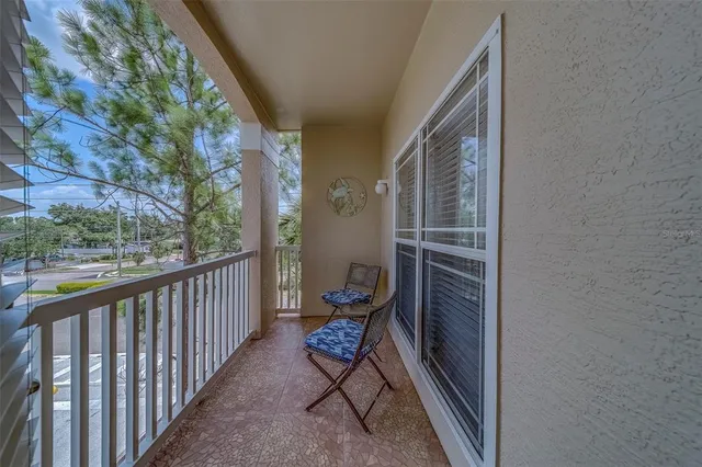 a view of a balcony with chair and wooden floor