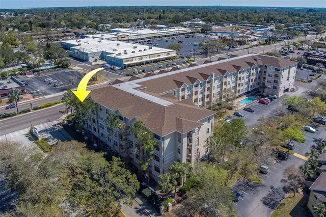 an aerial view of a house with a swimming pool yard and outdoor seating