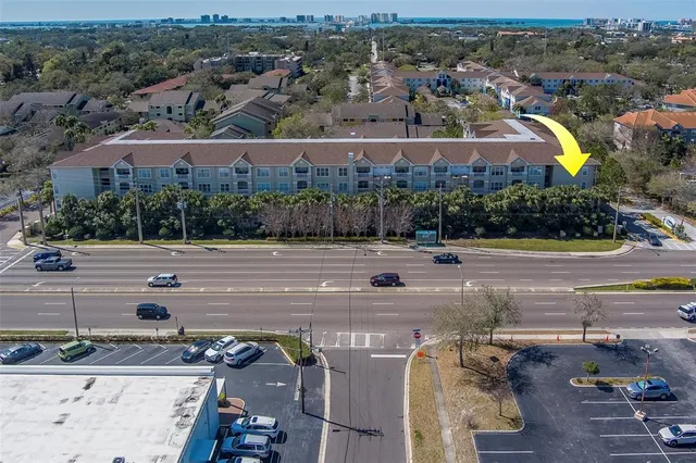 an aerial view of a building with garden space and ocean view
