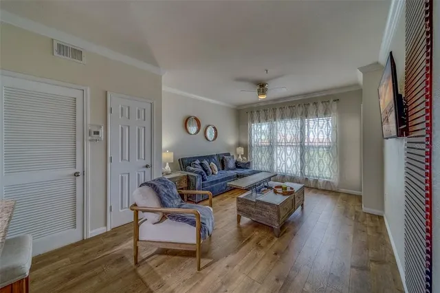 a living room with furniture and wooden floor
