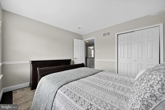 a bedroom with a bed and a night stand