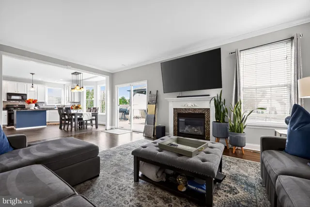 a living room with furniture fireplace and flat screen tv
