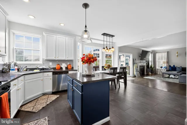 a kitchen view with stainless steel appliances granite countertop a stove and cabinets