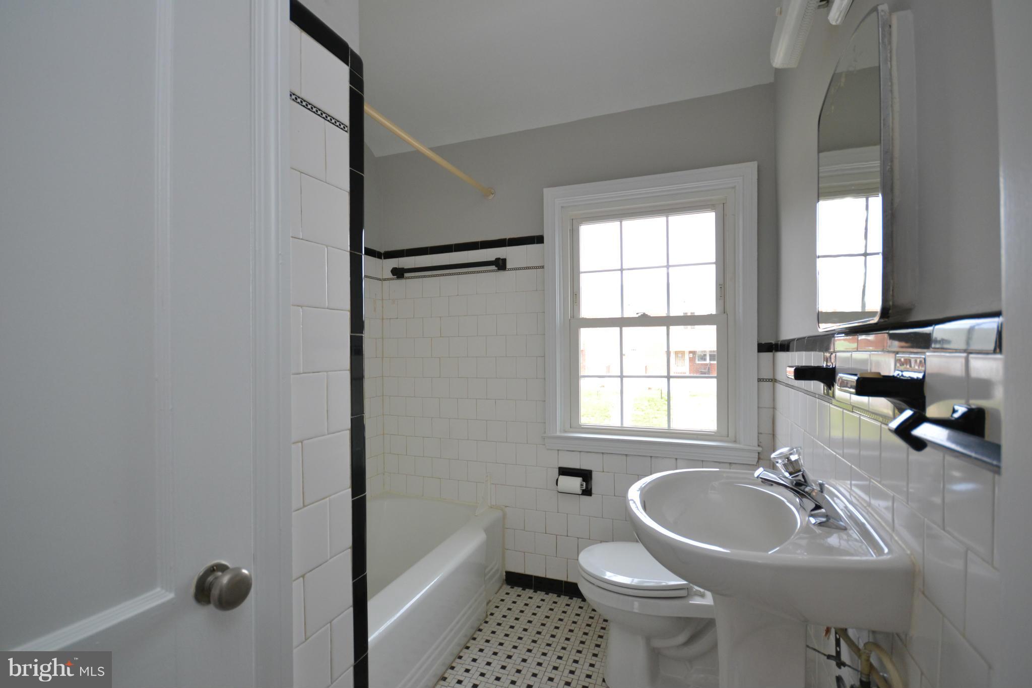 8635 Rock Oak Road Baltimore, MD 21234 - Photo 22 of 29 a bathroom with a sink toilet and a window