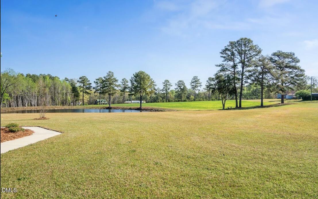 5780 McArthur Road Broadway, NC 27505 - Photo 7 of 40 a view of a swimming pool with an outdoor space and seating area