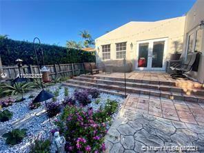 8926 Emerson Avenue Surfside, FL 33154 - Photo 17 of 18 a view of a house with backyard and garden