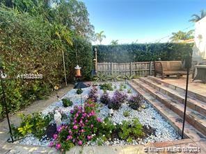 8926 Emerson Avenue Surfside, FL 33154 - Photo 18 of 18 a view of a backyard with pathway