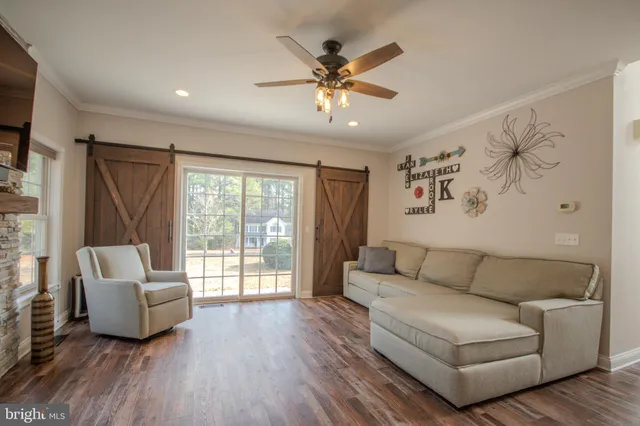 a living room with furniture fireplace and flat screen tv