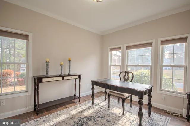 a view of a workspace with furniture window and wooden floor